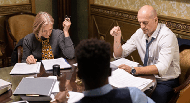 Employees working through paperwork 